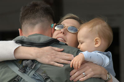 Pam, and son Ethan hug goodbye husband and father Maj. J.J., AV-8B pilot, who departed with Marine Attack Squadron 223 in support of the 26th Marine Expeditionary Unit (Special Operations Capable) March 5. Photo by: Pvt. Rocco DeFilippis